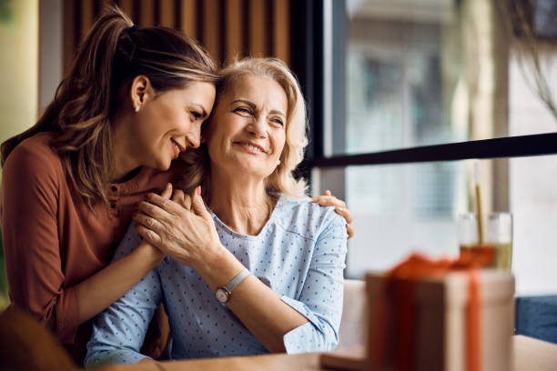 Happy senior woman enjoying in daughter's affection on Mother's day retreats for women